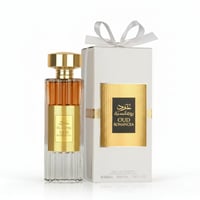 Ard Al Zaafaran Oud Romancea — Amber liquid perfume bottle with gold accents and ribbed glass, next to a white gift box with