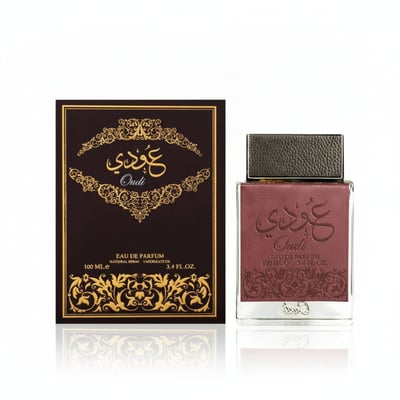Ard Al Zaafaran Oudi – Brown box with gold Arabic script and ornate pattern next to a maroon leather-accented glass bottle