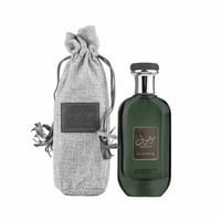 Ard Al Zaafaran Mousuf Ramadi — Green glass perfume bottle with silver cap next to a grey drawstring pouch with leather label