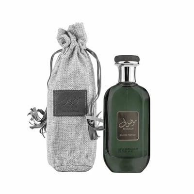 Ard Al Zaafaran Mousuf Ramadi — Green glass perfume bottle with silver cap next to a grey drawstring pouch with leather label