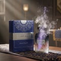 Ard Al Zaafaran Jazzab Silver – Man in car holding silver patterned fragrance bottle towards camera