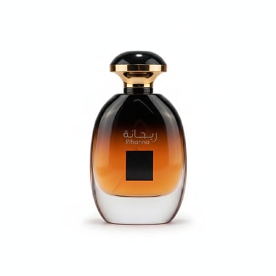Ard Al Zaafaran Rihanna — Amber gradient glass perfume bottle with black and gold cap, Arabic script and "Rihanna" text