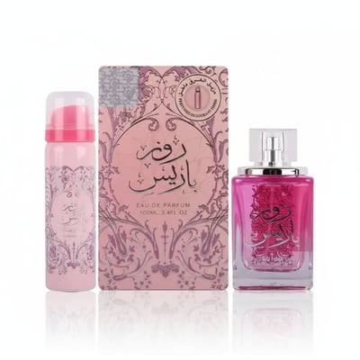 Ard Al Zaafaran Rose Paris — Pink floral patterned box with Arabic script, a pink aerosol can, and a pink glass perfume