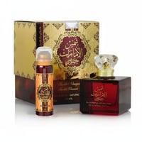 Ard Al Zaafaran Shams Al Emarat Khususi 100ml EDP Unisex — Kotak emas berhias, botol semburan kecil dan botol minyak wangi kaca merah gelap dengan penutup kristal.