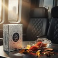 Ard Al Zaafaran Maraseem — Black perfume box with gold accents on a wooden walkway in a misty forest