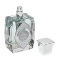 Ard Al Zaafaran Maraseem — Perfume bottle and box displayed on a patterned fabric with gold ornate borders and Arabic