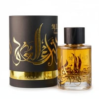 Ard Al Zaafaran Thara Al Oud — Black cylindrical box with gold Arabic calligraphy and a clear glass perfume bottle with gold