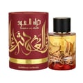 Ard Al Zaafaran Mousuf Wardi — Pink textured drawstring pouch with tassel next to a clear glass perfume bottle with pink