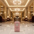 Al Wataniah Shagaf Al Ward — Pink perfume bottle with black faceted cap and tassel, on a soft pink background.