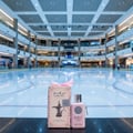Al Wataniah Shagaf Al Ward — Pink floral patterned box next to a glass perfume bottle with a black tassel and black cap.