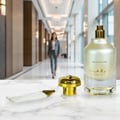 Al Wataniah Special Oud — Black and gold box with Arabic script next to a clear glass bottle with gold cap, emitting smoke.