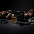Ard Al Zaafaran Oud Romancea — Amber liquid perfume bottle with gold accents and ribbed glass, next to a white gift box with