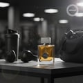 Ard Al Zaafaran Oud Romancea — Amber liquid perfume bottle with gold accents and ribbed glass, next to a white gift box with