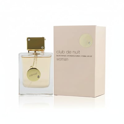Armaf Club De Nuit Woman — Clear glass perfume bottle with gold cap and chain charm next to a pale pink box