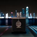 Armaf Club de Nuit Iconic 10ml EDP — Blue cylindrical packaging with holographic accents and a smaller matching spray bottle.