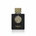 Ard Al Zaafaran Thara Al Oud — Clear glass bottle with gold liquid, black wooden cap, and ornate gold Arabic calligraphy