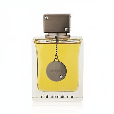 Armaf Club De Nuit Man — Black box with white circle and text next to a clear glass bottle of golden liquid with a silver tag