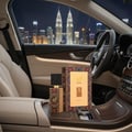 Armaf Club De Nuit Sillage — Perfume bottle and box on table with Petronas Towers at sunset