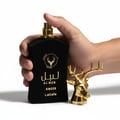 Armaf Imperiale Eau De Parfum Armaf 105ml — White bottle with gold cap and chain, placed on car's center console with purple