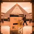 Armaf Odyssey Spectra — Rainbow striped bottle and black box displayed in a glass case in a mall.