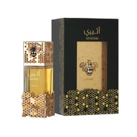 Lattafa Atheeri – Gold-accented perfume bottle with bee emblem next to its black and gold honeycomb patterned box.