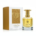 Lattafa Al Nashama Caprice — Blue glass perfume bottle with ornate gold and blue cap next to its white and blue marble