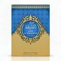 Lattafa Fire On Ice — Gold box with ornate design next to a clear glass perfume bottle with golden liquid and cap.