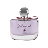 Maison Alhambra Just Married by Maison Alhambra Woman 100ml — A clear glass perfume bottle with a light purple hue, featuring a silver cap, a dark red ribbon tied around the neck, and the text 'Just married' with a deer logo and 'MAISON ALHAMBRA' below.