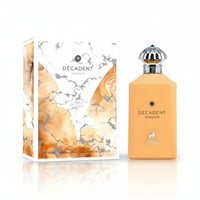 Maison Alhambra Decadent Wonder Her EDP 100 ml Alhambra — A peach-colored perfume bottle with a silver ornate cap stands next to its matching marble and watercolor patterned box.