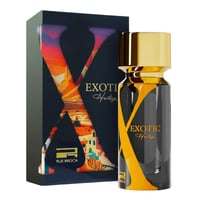 Rue Broca Exotic Heritage by Rue Broca 100ml EDP Men — A dark perfume bottle with a gold cap and yellow 'X' design, next to its matching dark blue box with a colorful 'X' cutout revealing a desert landscape.