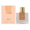 Lattafa Ana Abiyedh Coral — Rectangular glass perfume bottle with coral liquid, gold label, and black cap next to a white