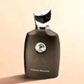Maison Alhambra Perseus Exclusif — A dark, smoky glass perfume bottle with a distinctive silver and black cap, featuring a circular emblem with a deer silhouette and the brand name. The text "PERSEUS EXCLUSIF" is visible at the bottom. | Maison Alhambra Perseus Exclusif — Botol minyak wangi kaca gelap berasap dengan