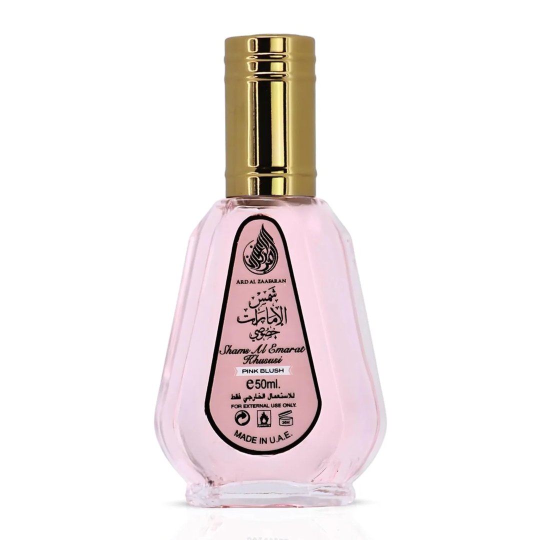 Ard Al Zaafaran Pink Blush Shams Al Emarat Khususi 50ml — Pink glass perfume bottle with a gold cap, featuring a black label with Arabic and English text, and a pink blush scent indication.