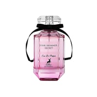 Maison Alhambra Pink Shimmer Secret 100ml — A pink perfume bottle with a black ribbon bow and a matching pink and white striped box are displayed side-by-side against a white background. | Maison Alhambra Pink Shimmer Secret 100ml — Sebotol minyak wangi merah jambu dengan reben hitam dan kotak merah jambu berjalur