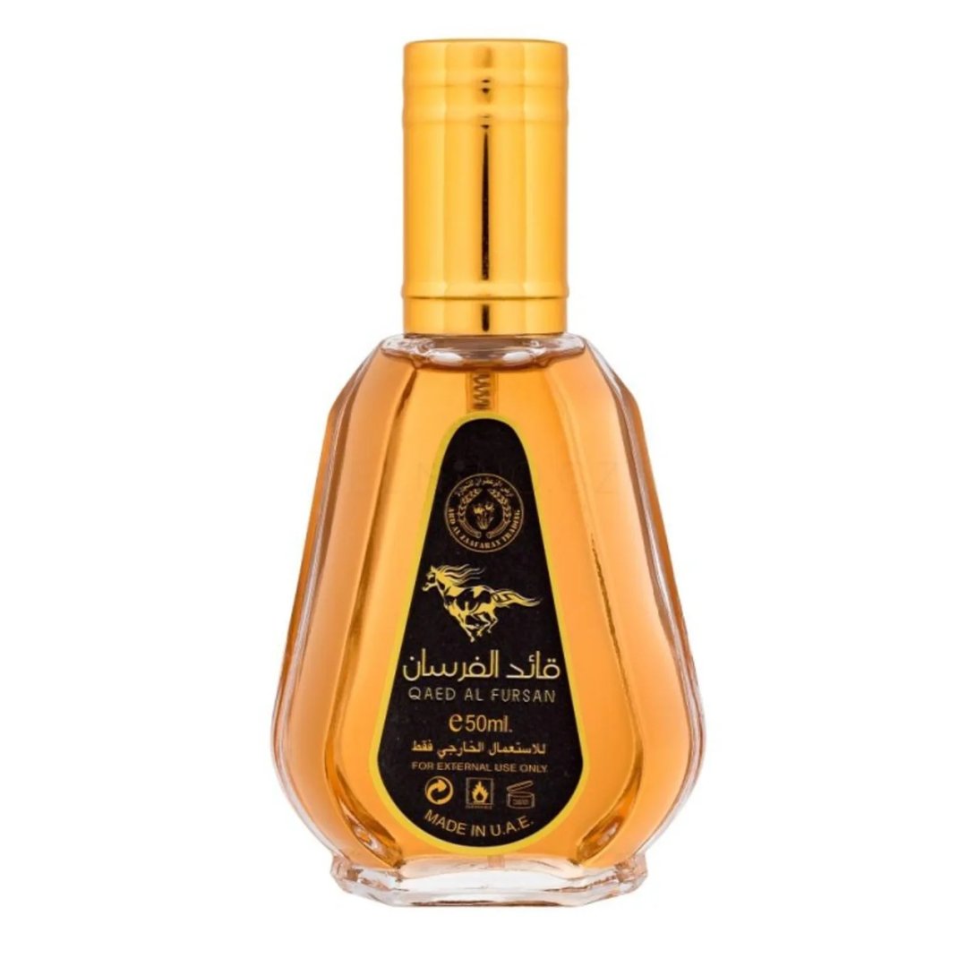Ard Al Zaafaran Qaed Al Fursan — A clear glass perfume bottle with a gold cap and a black label featuring a horse silhouette and Arabic text. | Ard Al Zaafaran Qaed Al Fursan — Botol kaca jernih dengan penutup emas dan label hitam menampilkan siluet kuda dan teks Arab.