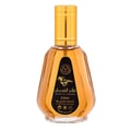 Ard Al Zaafaran Qaed Al Fursan — A clear glass perfume bottle with a gold cap and a black label featuring a horse silhouette and Arabic text. | Ard Al Zaafaran Qaed Al Fursan — Botol kaca jernih dengan penutup emas dan label hitam menampilkan siluet kuda dan teks Arab.