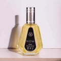Ard Al Zaafaran Rave Now 50ml EDP for Men — Clear glass perfume bottle with yellow liquid, silver cap, and black label with white text, casting a shadow on a white background.