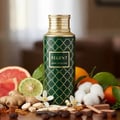 Regent by Maison Asrar 100ml EDP Unisex — Botol hijau corak emas, penutup emas, dikelilingi limau gedang, limau nipis, halia, kapas, dan buah sitrus.