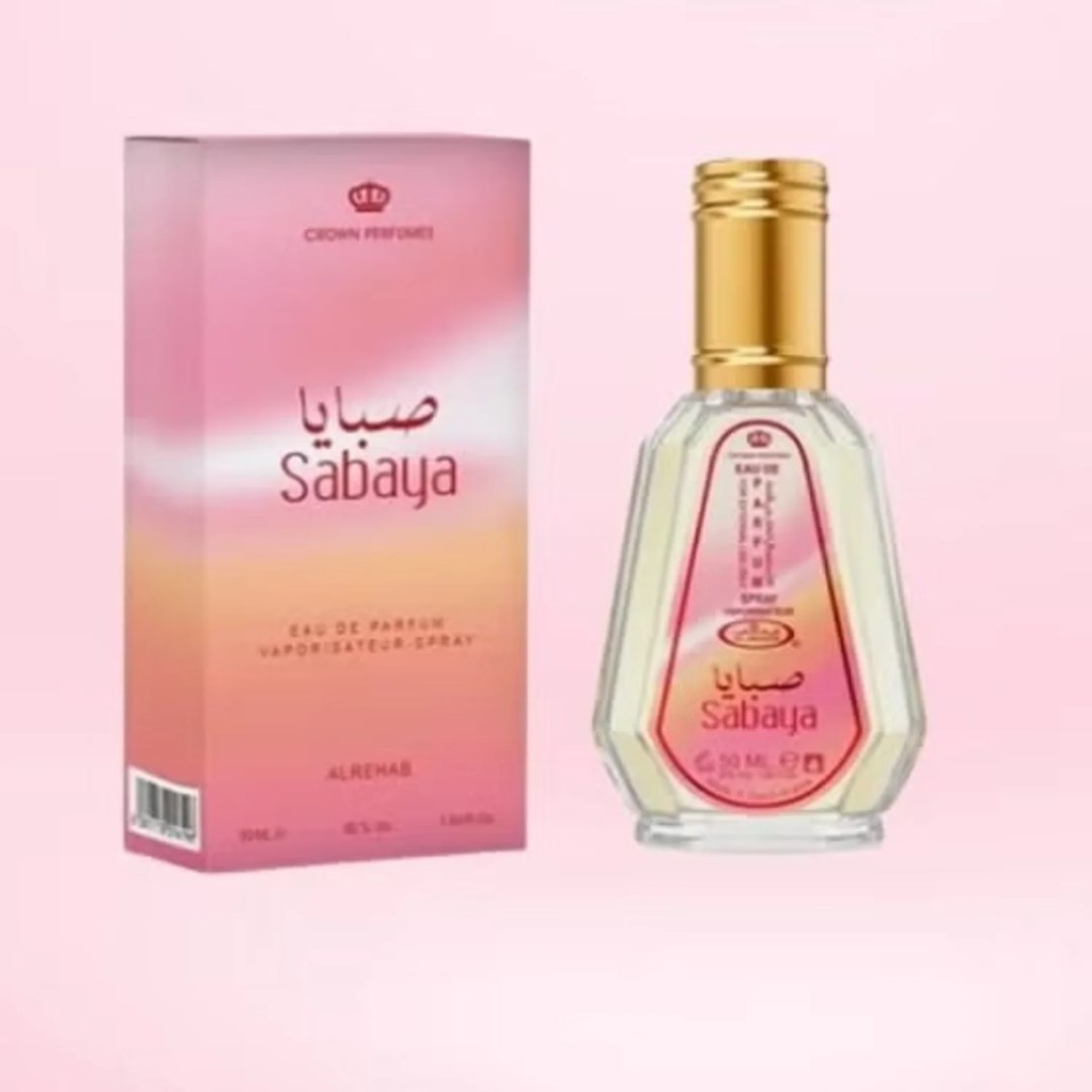 Al Rehab Sabaya by Al-Rehab 50ml EDP — A pink and orange gradient box sits to the left of a clear glass perfume bottle with a gold cap, both featuring the 'Sabaya' label. | Al Rehab Sabaya by Al-Rehab 50ml EDP — Kotak bergradien merah jambu dan jingga terletak di sebelah kiri botol minyak wangi kaca jernih dengan