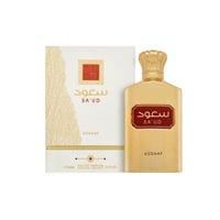 Asdaaf Sa'ud by Asdaaf 100ml EDP Unisex — Botol minyak wangi emas dengan penutup gaya mahkota dan label merah, bersebelahan kotak putih bermotif emas.