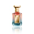 Velixir Selene Velixir Parfums 100ml — A clear glass perfume bottle with a gradient of pink to blue liquid, a gold label with "SELENE EAU DE PARFUM" text, and a faceted gold cap, reflected on a white surface. | Velixir Selene Velixir Parfums 100ml — Botol kaca jernih berisi minyak wangi dengan gradien cecair merah