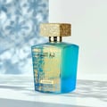 Lattafa Sheikh Al Shuyukh Supreme — A blue glass perfume bottle with gold Arabic script and a textured gold cap, set against a blurred blue and white patterned background with strong shadows. | Botol minyak wangi kaca biru dengan tulisan Arab emas dan penutup emas bertekstur, diletakkan berlatarkan latar belakang