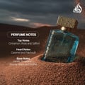 Lattafa Sheikh Al Shuyukh Supreme by Lattafa 100ml — A blue glass perfume bottle with a textured gold cap sits partially buried in sand, with desert dunes and a dark sky in the background. | Lattafa Sheikh Al Shuyukh Supreme by Lattafa 100ml — Botol minyak wangi kaca biru dengan penutup emas bertekstur duduk separuh