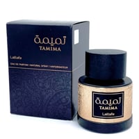 Lattafa Tamima by Lattafa 100 ml Eau de Parfum — A dark blue box with gold Arabic script and text 'TAMIMA' and 'Lattafa' sits next to a matching dark bottle with a gold patterned label and a dark wooden cap. | Lattafa Tamima by Lattafa 100 ml Eau de Parfum — Kotak biru gelap dengan tulisan Arab emas dan teks 'TAMIMA'