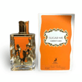 Maison Alhambra Sugar Me Carrot Cake — Clear glass perfume bottle with orange dripping design and gold accents, next to its orange and white box.