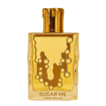 Maison Alhambra Sugar Me Creme Brulee — A clear glass perfume bottle with a gold cap resembling dripping wax. The bottle has a golden liquid inside and a decorative caramel-like design on the front.