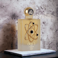 Lattafa Pride Tharwah Gold by Lattafa Pride 100ml EDP — Frosted gold glass perfume bottle with a gold atom-like emblem and black spheres, set against a textured grey background.