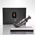 Niche Emarati Khanjar by Niche Emarati 85ml EDP — Ornate silver dagger-shaped perfume bottle displayed on a stand in front of a black presentation box with the brand logo.