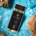Maison Alhambra Sceptre Oceana — Black perfume bottle with gold accents and blue gem, set against a vibrant blue water background with rocks.