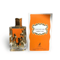 Maison Alhambra Sugar Me Carrot Cake — Clear glass perfume bottle with orange design and gold cap, next to its orange product box with ornate frame